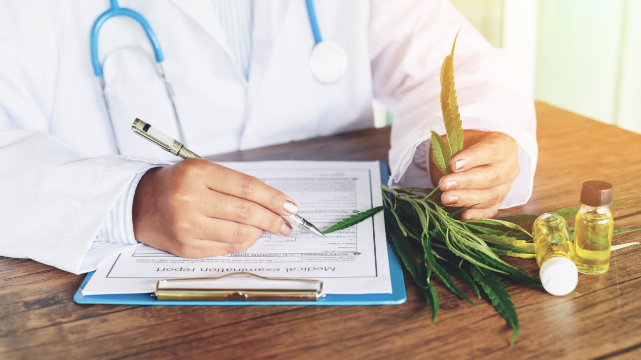 Ein Arzt füllt ein Cannabis Rezept für einen Patienten aus